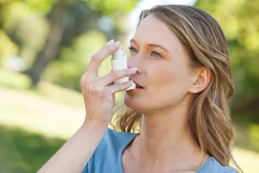 kobieta chorująca na astmę korzysta z inhalatora